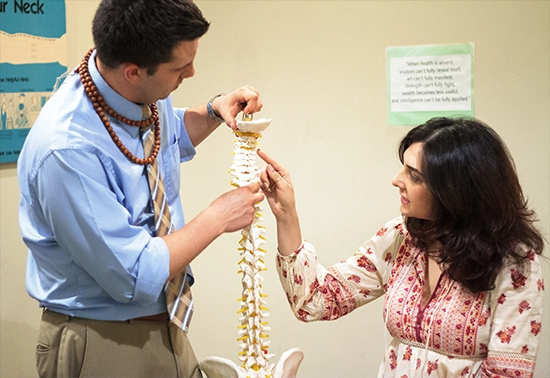 Chiropractor Hollywood CA Brian Pazera with patient consultation